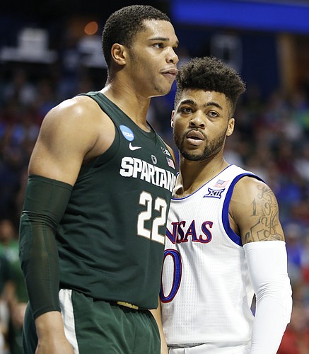 Michigan State forward Miles Bridges (22) and Kansas guard Frank Mason III (0) get up close after a drive by Mason during the first half on Sunday, March 19, 2017 at BOK Center in Tulsa, Okla.