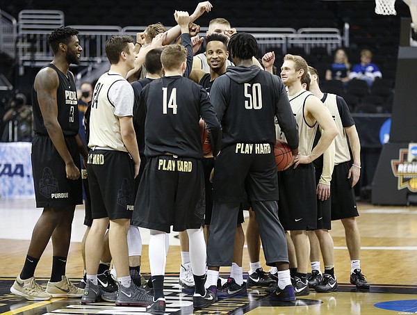 The Purdue Boilermakers come together at half court after a practice on Wednesday prior to Thursday's game at Sprint Center in Kansas City, Mo.