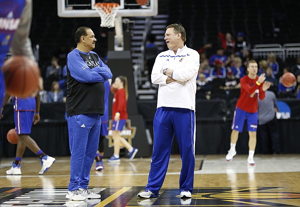 Kansas head coach Bill Self, right, and assistant Kurtis Townsend chat at half court during a day of practices and press conferences prior to a March 2017 KU game at Sprint Center in Kansas City, Mo.
