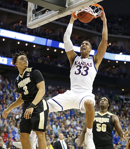 Kansas forward Landen Lucas (33) powers in a dunk against Purdue guard Carsen Edwards (3) and Purdue forward Caleb Swanigan (50) during the second half, Thursday, March 23, 2017 at Sprint Center in Kansas City, Mo.