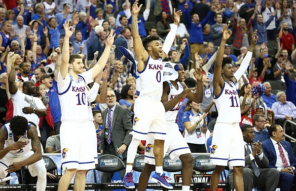 The Kansas bench reacts to a three pointer by Kansas forward Mitch Lightfoot late in the second half, Thursday, March 23, 2017 at Sprint Center in Kansas City, Mo.