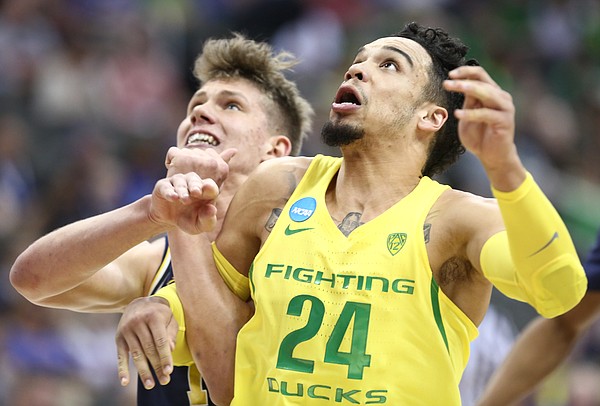 Oregon forward Dillon Brooks (24) fights for position against Michigan forward Moritz Wagner (13) during the first half, Thursday, March 23, 2017 at Sprint Center in Kansas City, Mo.