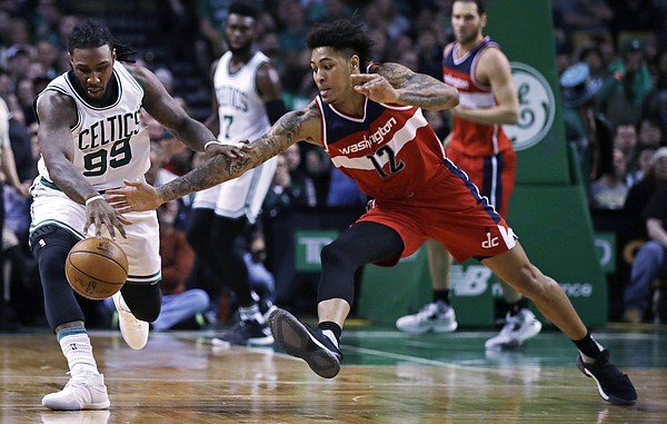 Boston Celtics forward Jae Crowder (99) and Washington Wizards forward Kelly Oubre Jr. (12) battle for a loose ball during the second half of an NBA basketball game in Boston, Monday, March 20, 2017. The Celtics defeated the Wizards 110-102. (AP Photo/Charles Krupa)