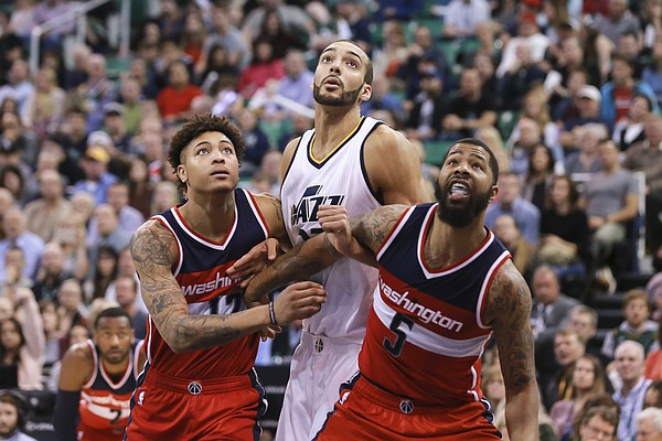 Washington Wizards forward Kelly Oubre Jr. (12) and Washington Wizards forward Markieff Morris (5) try to keep Utah Jazz center Rudy Gobert (27) from getting the rebound from a foul shot during the fourth quarter of NBA basketball game Friday, March 31, 2017, in Salt Lake City. The Utah Jazz won the game 95-88. (AP Photo/Chris Nicoll)