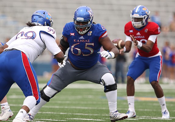 Team KU offensive lineman Jayson Rhodes (65) looks to fend off Team Jayhawk defensive tackle DeeIsaac Davis (99) during the third quarter of the 2017 Spring Game on Saturday, April 15 at Memorial Stadium.