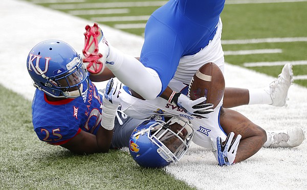 Team Jayhawks receiver Daylon Charlot rolls over out of bounds after pulling in a catch while covered by Team KU cornerback Julian Chandler (25) during the second quarter of the 2017 Spring Game on Saturday, April 15 at Memorial Stadium.