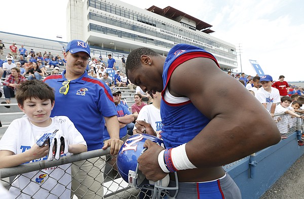 Kansas defensive end Dorance Armstrong Jr. signs autographs following the 2017 Spring Game on Saturday, April 15 at Memorial Stadium.