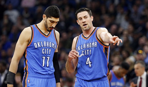 Oklahoma City Thunder's Enes Kanter, left, of Turkey, and Nick Collison confer during the second half of an NBA basketball game against the Minnesota Timberwolves Tuesday, April 11, 2017, in Minneapolis. (AP Photo/Jim Mone)