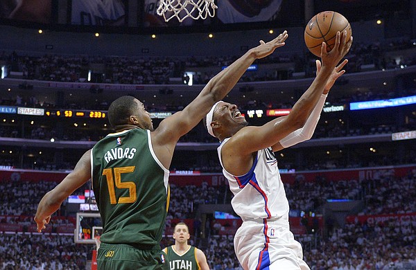 Los Angeles Clippers forward Paul Pierce, right, shoots as Utah Jazz forward Derrick Favors defends during the second half in Game 7 of an NBA basketball first-round playoff series, Sunday, April 30, 2017, in Los Angeles. The Jazz won 104-91. (AP Photo/Mark J. Terrill)