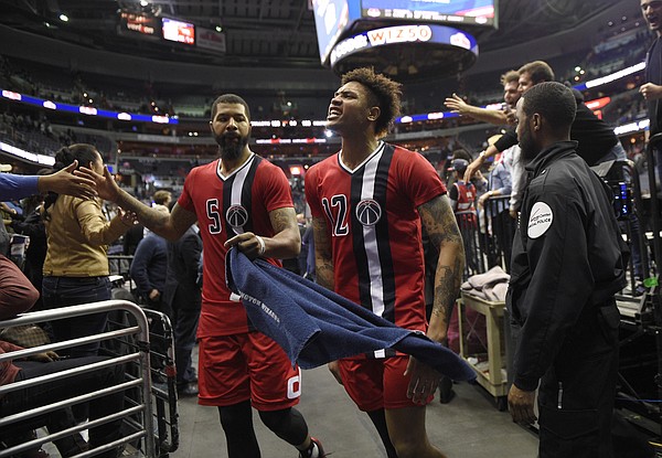Washington Wizards' Kelly Oubre Jr. (12) and Markieff Morris (5) leave the court after the team's NBA basketball game against the Boston Celtics, Tuesday, Jan. 24, 2017, in Washington. The Wizards won 123-108. (AP Photo/Nick Wass)