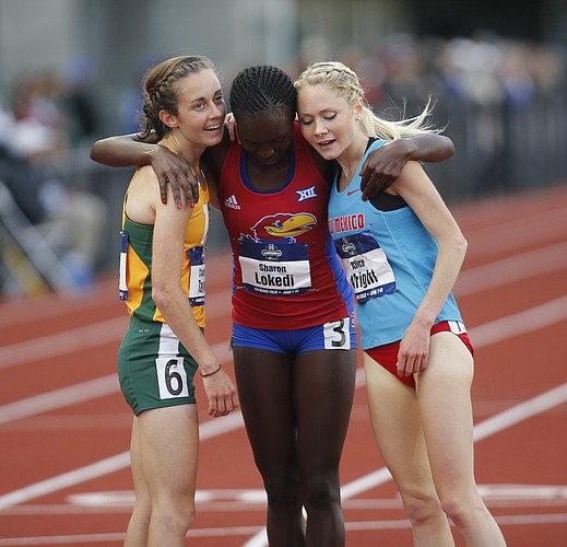 San Francisco's Charlotte Taylor, left, Kansas' Sharon Lokedi, center, and New Mexico's Alice Wright, right, embrace after finishing the women's 10,000 meters on the second day of the NCAA outdoor college track and field championships in Eugene, Ore., Thursday, June 8, 2017. Taylor won the race in 32 minutes, 38.57 seconds. (AP Photo/Timothy J. Gonzalez)
