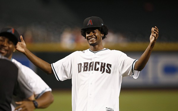 Former KU star Josh Jackson laughs and throws up his hands after firing out a horrific ceremonial first pitch at Friday's Arizona Diamondbacks game. (AP Photo) 