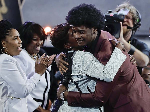 Kansas' Josh Jackson, right, hugs friends and relatives after being selected by the Phoenix Suns as the fourth pick overall during the NBA basketball draft, Thursday, June 22, 2017, in New York. (AP Photo/Frank Franklin II)