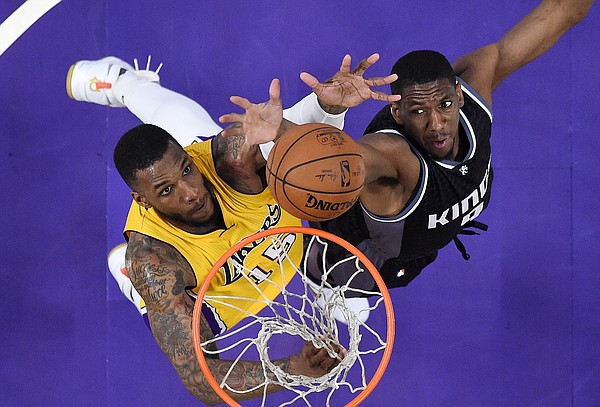 Los Angeles Lakers forward Thomas Robinson, left, and Sacramento Kings guard Langston Galloway reach for a rebound during the second half of an NBA basketball game, Friday, April 7, 2017, in Los Angeles. The Lakers won 98-94. (AP Photo/Mark J. Terrill)