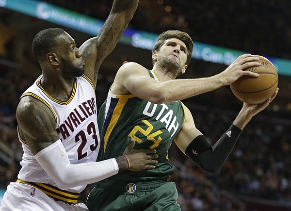 Utah Jazz's Jeff Withey (24) drives against Cleveland Cavaliers' LeBron James (23) in the first half of an NBA basketball game, Thursday, March 16, 2017, in Cleveland. (AP Photo/Tony Dejak)