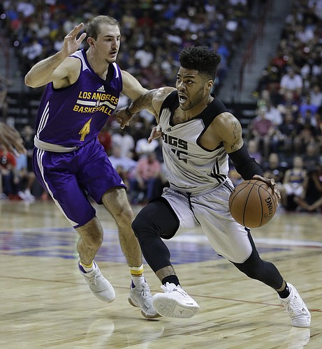 Sacramento Kings' Frank Mason III drives around Los Angeles Lakers' Alex Caruso during the first half of an NBA summer league basketball game, Monday, July 10, 2017, in Las Vegas. (AP Photo/John Locher)