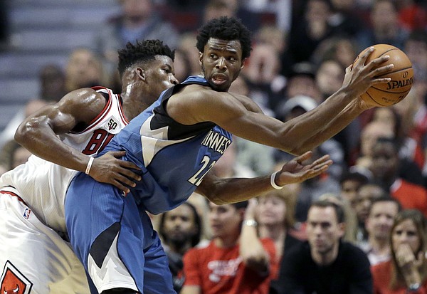 FILE — Minnesota Timberwolves guard/forward Andrew Wiggins, right, looks to a pass as Chicago Bulls guard/forward Jimmy Butler guards during overtime of an NBA basketball game on Saturday, Nov. 7, 2015, in Chicago. The Timberwolves acquired Butler via trade this summer and now the two are teammates. (AP Photo/Nam Y. Huh)