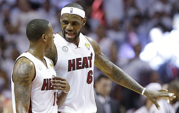 FILE — The Miami Heat's LeBron James (6) speaks with Mario Chalmers (15) during the first half in Game 7 of the NBA basketball championships against the San Antonio Spurs, Thursday, June 20, 2013, in Miami. (AP Photo/Lynne Sladky)