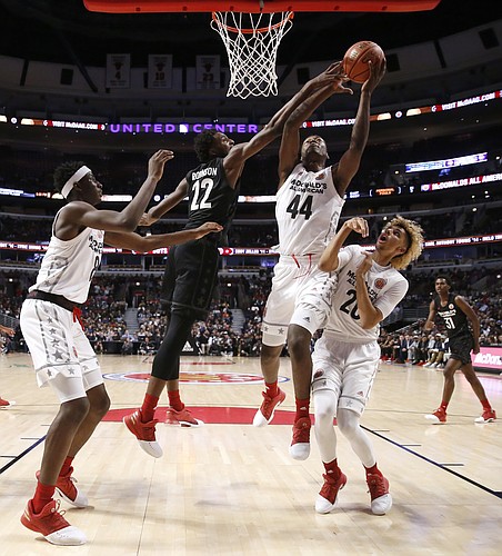 Big East's Mitchell Robinson (22) blocks the shot of Big West's Brandon L. McCoy (44) as Jaren Jackson Jr., left, and Brian "Tugs" Bowen II, watch during the second half of the McDonald's All-American boys basketball game Wednesday, March 29, 2017, in Chicago. The West team won 109-107. (AP Photo/Nam Y. Huh)
