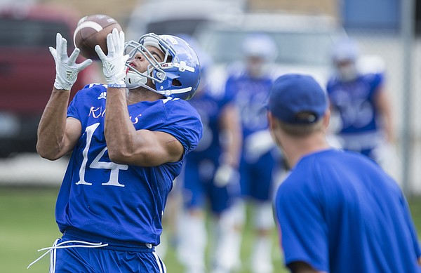 Kansas receiver Kerr Johnson Jr. pulls in a catch during practice on Friday, Aug. 18, 2017 at the grass fields adjacent to Hoglund Ballpark.