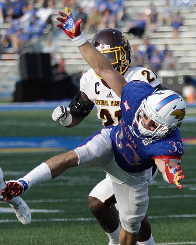 Kansas wide receiver Ryan Schadler (33) is bumped by CMU defensive back Josh Cox (21) during the Jayhawks game against Central Michigan Saturday, Sept. 9 at Memorial Stadium. Pass interference was called on Cox. 