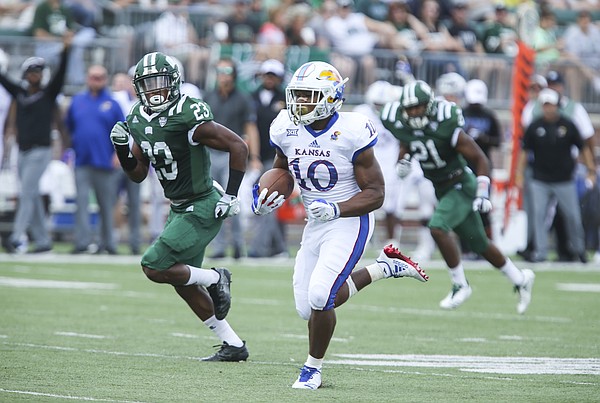 Kansas running back Khalil Herbert (10) takes off on a touchdown run past Ohio safety Kylan Nelson (23) during the second quarter on Saturday, Sept. 16, 2017 at Peden Stadium in Athens, Ohio.
