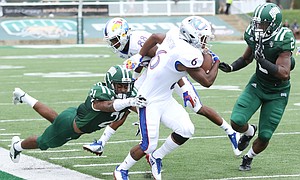 Kansas wide receiver Quan Hampton (6) is pushed out of bounds by Ohio cornerback Jalen Fox (21) and Ohio cornerback Mayne Williams (2) during the fourth quarter on Saturday, Sept. 16, 2017 at Peden Stadium in Athens, Ohio.