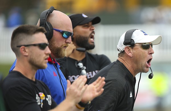 Kansas head coach David Beaty, right, screams from the sidelines during the third quarter on Saturday, Sept. 16, 2017 at Peden Stadium in Athens, Ohio.