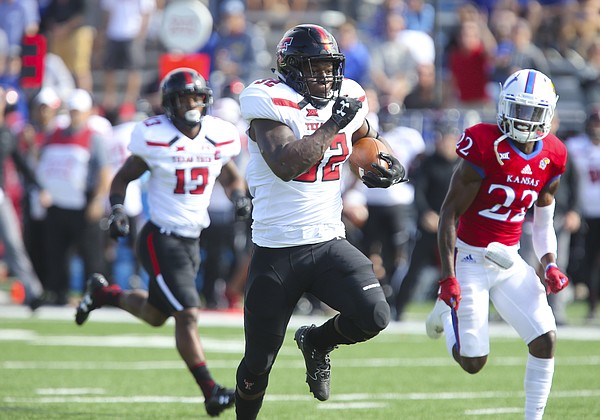Texas Tech running back Desmond Nisby (32) runs up the field past Kansas safety Tyrone Miller Jr. (22) for a touchdown during the first quarter on Saturday, Oct. 7, 2017 at Memorial Stadium.