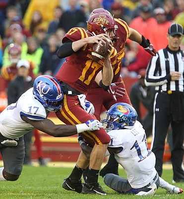Kansas defensive end Josh Ehambe (17) and Kansas safety Mike Lee (11) bring down Iowa State quarterback Kyle Kempt (17) for a sack during the second quarter on Saturday, Oct. 14, 2017 at Jack Trice Stadium in Ames, Iowa.