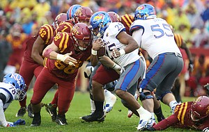 Kansas running back Dom Williams (25) is hit by Iowa State defensive end J.D. Waggoner (58) on a run during the second quarter on Saturday, Oct. 14, 2017 at Jack Trice Stadium in Ames, Iowa.