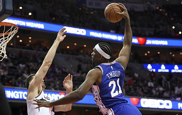 Philadelphia 76ers center Joel Embiid (21) goes to the basket against Washington Wizards forward Jason Smith, left, during the first half of an NBA basketball game, Wednesday, Oct. 18, 2017, in Washington. Smith was charged with a foul on the play.(AP Photo/Nick Wass)