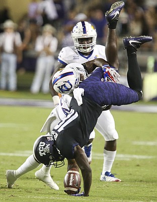 TCU wide receiver Jalen Reagor (18) is upended by Kansas safety Tyrone Miller Jr. (22) during the first quarter, Saturday, Oct. 21, 2017 at Amon G. Carter Stadium in Fort Worth.