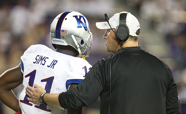 Kansas head coach David Beaty  talks with punt returner Steven Sims Jr. just before a punt in the second quarter, Saturday, Oct. 21, 2017 at Amon G. Carter Stadium in Fort Worth.