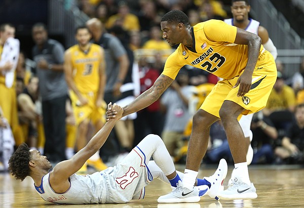Missouri forward Jeremiah Tilmon (23) gives Kansas guard Devonte' Graham (4) a hand off the floor after fouling him during the second half of the Showdown for Relief exhibition, Sunday, Oct. 22, 2017 at Sprint Center in Kansas City, Missouri.