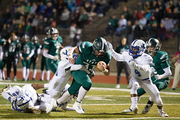 Free State junior running back Jax Dineen tries to break a few tackles against Junction City on Friday at FSHS. 