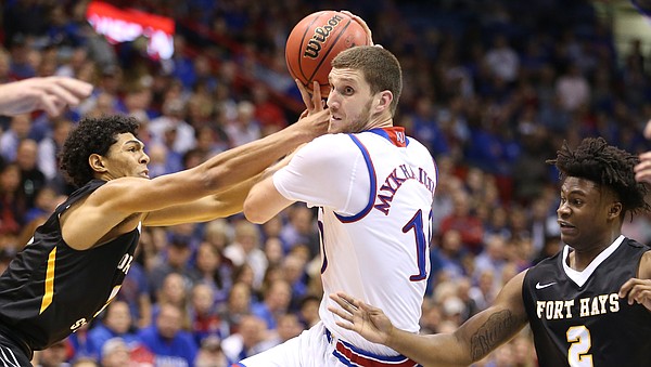 Kansas guard Sviatoslav Mykhailiuk (10) moves in to the bucket between Fort Hays State guard Keshawn Wilson (0) and Fort Hays State guard Nyjee Wright (2) during the second half, Tuesday, Nov. 7, 2017 at Allen Fieldhouse.