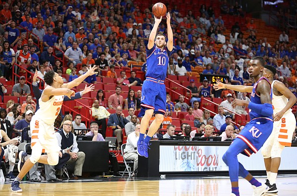 Kansas guard Sviatoslav Mykhailiuk (10) spots up for a three before Syracuse forward Matthew Moyer (2) during the first half, Saturday, Dec. 2, 2017 at American Airlines Arena in Miami.