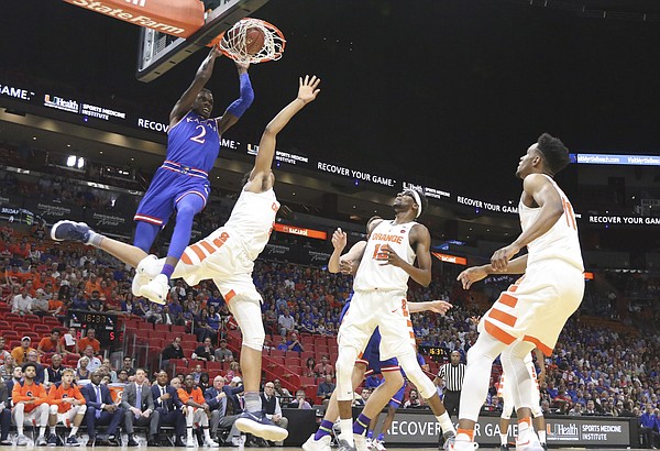 Kansas guard Lagerald Vick (2) delivers on a lob jam over Syracuse forward Matthew Moyer (2) during the first half, Saturday, Dec. 2, 2017 at American Airlines Arena in Miami.