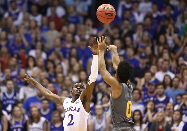 Kansas guard Lagerald Vick (2) defends against a shot from Arizona State guard Tra Holder (0) during the first half, Sunday, Dec. 10, 2017 at Allen Fieldhouse.