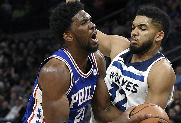 Philadelphia 76ers center Joel Embiid (21), of Cameroon, drives against Minnesota Timberwolves center Karl-Anthony Towns (32) during the second quarter of an NBA basketball game on Tuesday, Dec. 12, 2017, in Minneapolis. The 76ers won 118-112. (AP Photo/Hannah Foslien)


