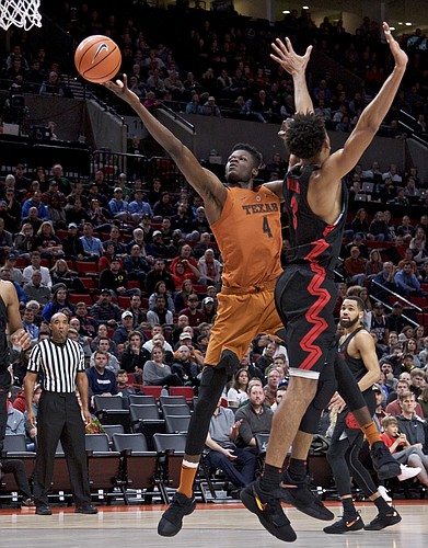 Texas forward Mohamed Bamba, left, shoots over Gonzaga forward Johnathan Williams during the second half of an NCAA college basketball game in the Phil Knight Invitational tournament in Portland, Ore., Sunday, Nov. 26, 2017.