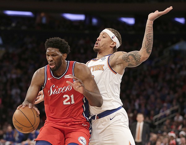 Philadelphia 76ers' Joel Embiid, left, and New York Knicks' Michael Beasley battle for position during the second half of an NBA basketball game, Monday, Dec. 25, 2017, in New York. The 76ers defeated the Knicks 105-98. (AP Photo/Seth Wenig)