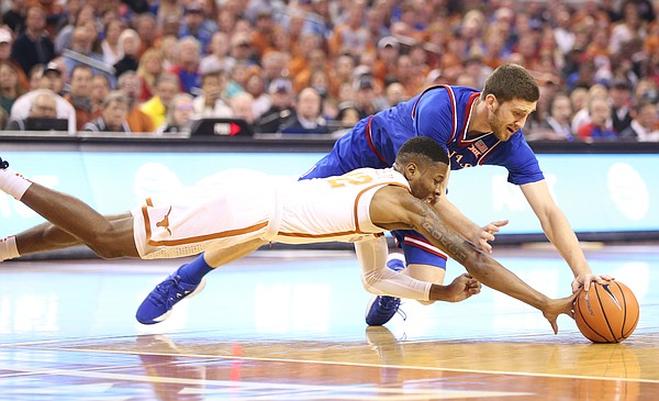 Kansas guard Sviatoslav Mykhailiuk (10) and Texas guard Kerwin Roach II (12) compete for a loose ball during the first half on Friday, Dec. 29, 2017 at Frank Erwin Center in Austin, Texas.