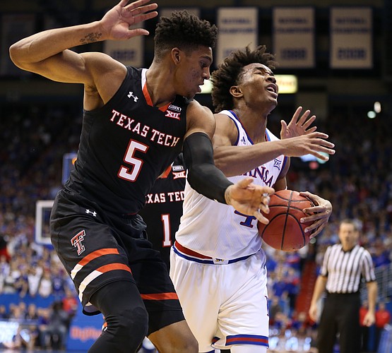 Kansas guard Devonte' Graham (4) is hounded by Texas Tech guard Justin Gray (5) during the first half, Tuesday, Jan. 2, 2018 at Allen Fieldhouse.