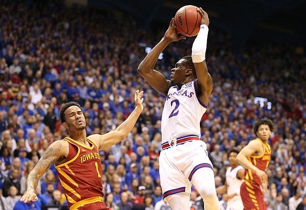Kansas guard Lagerald Vick (2) sends Iowa State guard Nick Weiler-Babb (1) to the floor after a charge during the first half, Tuesday, Jan. 9, 2018 at Allen Fieldhouse.