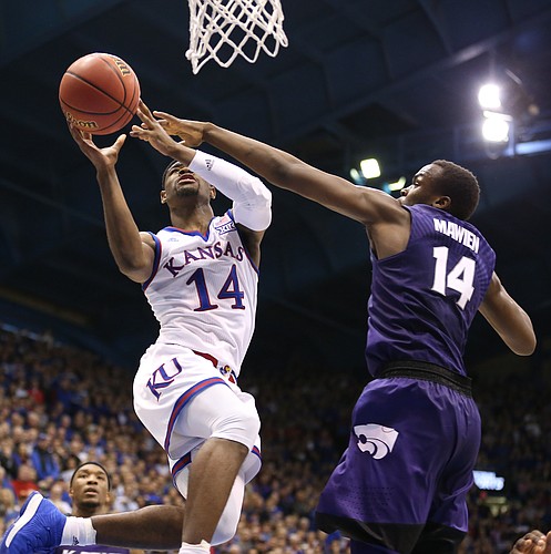 Kansas guard Malik Newman (14) is fouled on the shot by Kansas State forward Makol Mawien (14) with seconds remaining during the second half, Saturday, Jan. 13, 2018 at Allen Fieldhouse.
