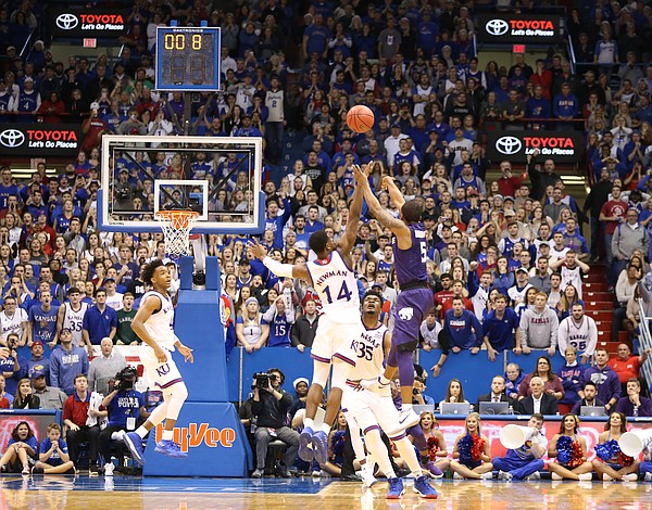 Kansas State guard Barry Brown (5) puts up a three defended by Kansas guard Malik Newman (14) with less than a second remaining in regulation, Saturday, Jan. 13, 2018 at Allen Fieldhouse.