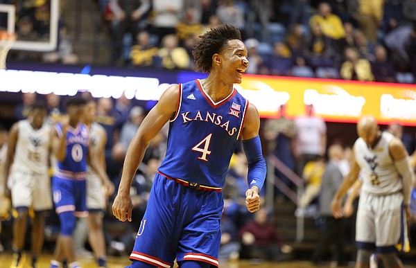 Kansas guard Devonte' Graham (4) and the Jayhawks celebrate their 71-66 win over West Virginia as time expires, Monday, Jan. 15, 2018 at WVU Coliseum in Morgantown, West Virginia.