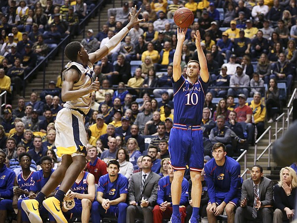 Kansas guard Sviatoslav Mykhailiuk (10) puts up a three from the corner against West Virginia forward Lamont West (15) during the second half, Monday, Jan. 15, 2018 at WVU Coliseum in Morgantown, West Virginia.